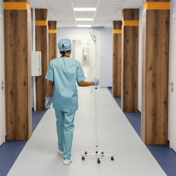 full-shot-nurse-walking-hall full-shot-nurse-walking-hall